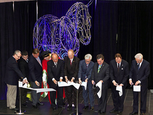 Ribbon cutting in front of the True Power sculpture at ERC opening (from left: John Henry, Oshawa Mayor; Glen Courtis Jr., Ontario Tech University Engineering Students' Society; Jeffrey Boyce, Sure Energy Inc.; Dr. Richard Marceau, Ontario Tech University provost and VP Academic; Roger Anderson, Chair and CEO, Durham Region; Joe Dickson, Ajax-Pickering MPP; Dr. Tim McTiernan, Ontario Tech University president; Jim Flaherty, Federal Finance Minister and Whitby-Oshawa MP; Dr. Colin Carrie, Oshawa MP; and Dr. George Bereznai, dean, Faculty of Energy Systems and Nuclear Science.